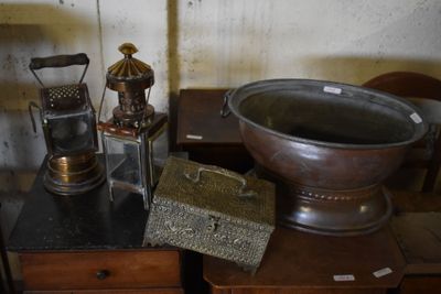 a large metal bowl sitting on top of a wooden table
