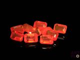 a lot of red plastic cubes on a black surface