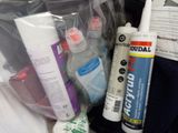 many different types of glues and other items in the bag