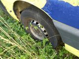 a yellow car that is sitting in the grass