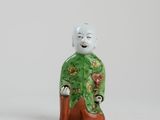 a small figurine of a man in a green outfit
