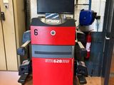 an image of a red and black machine in a garage