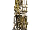 a brass sculpture of a musical instrument on a black base