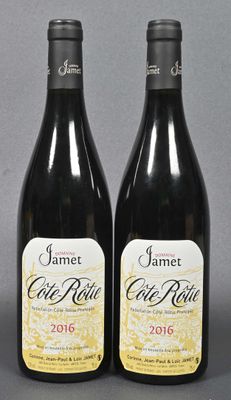 two bottles of wine sitting next to each other on a table