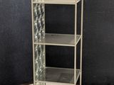 an image of a metal shelf with glass shelves in a room
