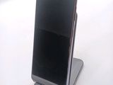 a cell phone that is sitting on top of a stand