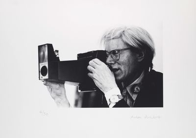 black and white photograph of a man taking a picture with a camera
