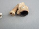 a pipe and a pipe holder on a table
