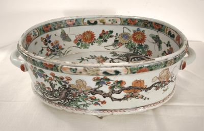 a white bowl with flowers on it on a table