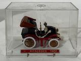 a small toy car in a clear box on a table