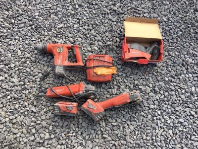 a group of tools sitting on top of a pile of gravel