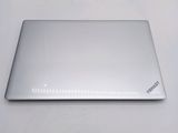 a silver laptop sitting on a table with a white background