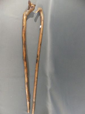 a wooden stick with a bird on top of it