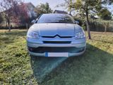 the car is parked on the grass in the yard