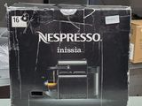 a box of nespresso coffee machine sitting on a table