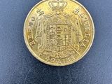 une pièce d'or sur laquelle est représenté un château