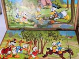 two pieces of a puzzle board with a picture of donald duck and donald duck