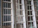 many old wooden ladders hanging on the wall