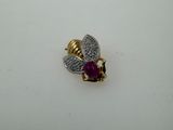 a close up of a gold and diamond bee brooch
