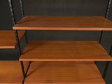 three tiered wooden shelving with metal legs and a black background