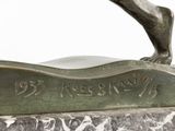 bronze sculpture of a horse on a marble base with a name plate