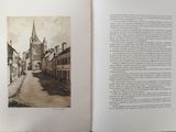 an open book with a picture of a church in the background