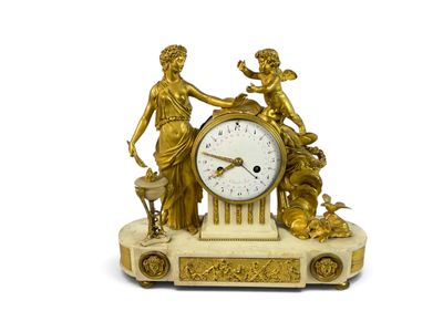a gold clock with a statue on top of it