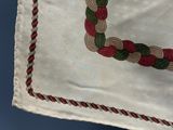 a white bag with a red and green design on it