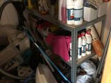 a shelf with a lot of cleaning supplies on it