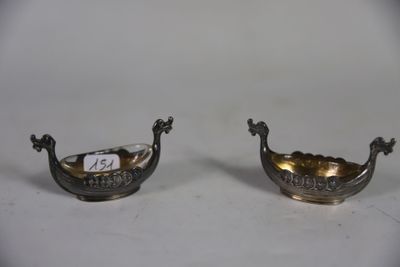 pair of silver plated bowls with handles on a white surface