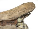 a piece of drift wood that has writing on it