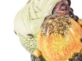 a ceramic figurine of a turkey with vegetables on it