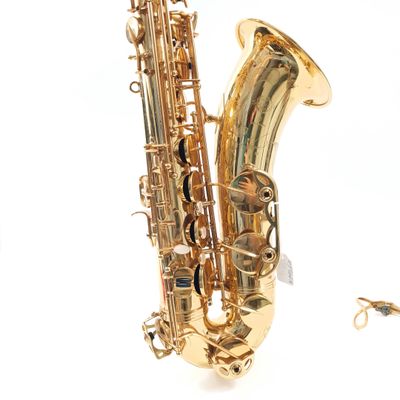 a saxophone that is laying on the ground next to a pair of scissors