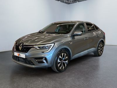 the grey car is parked in a large room with a black floor