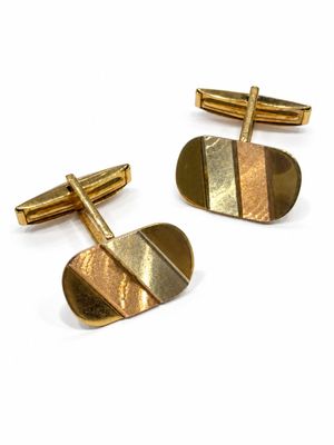 two pairs of gold cufflinks with a curved design