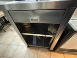 a stainless steel oven with a door open on a tiled floor