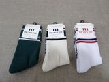 three pairs of men ' s socks sitting on top of a table