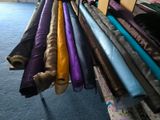 a lot of different colors of fabric hanging on a rack