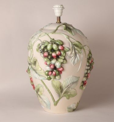 a white vase with a green and red design on it