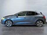 the blue car is parked in a large room with a white wall