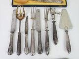a lot of silverware on a table with a knife and fork