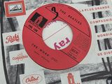 an old record with a red label on it sitting on top of a table