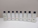 six bottles of hand sanitizer are lined up on a table