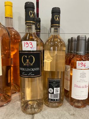 several bottles of wine are lined up on a counter