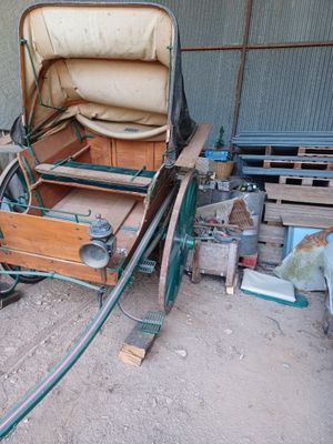 a horse drawn carriage that is sitting in the dirt