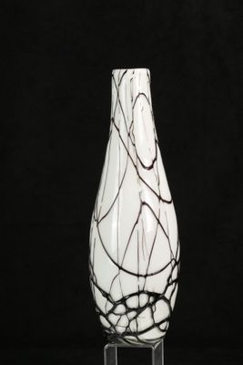 a white vase with black and white swirly designs on it