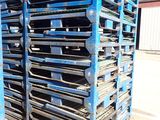 a stack of pallets sitting on top of each other in front of a building