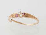 an 18k gold ring with pink sapphire and diamonds