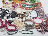 a pile of assorted necklaces and bracelets on a table