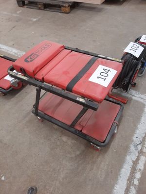 a red stretcher with a number on it in a warehouse